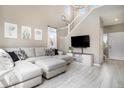 Bright living room with a soaring ceiling, large sectional couch, and modern finishes at 4307 Beautiful Cir, Castle Rock, CO 80109