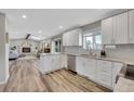 Open-concept kitchen with white cabinetry, granite counters, stainless steel appliances, and seamless flow into the living area at 9749 Meade Cir, Westminster, CO 80031