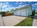 Spacious detached three car garage with white doors and ample parking space at 1391 Elmira St, Aurora, CO 80010