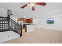 Open floor plan living area with staircase, kitchen view, and abundant natural light at 11935 Riverstone Cir # 6D, Henderson, CO 80640