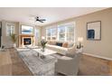 Bright living room features a fireplace and large windows at 3272 Brushwood Dr, Castle Rock, CO 80109