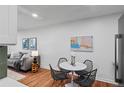 Cozy dining area features a round table and views into the living room at 7615 E Quincy Ave # 103, Denver, CO 80237