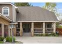 Inviting front porch featuring stone columns, and mature landscaping in a classic, well-maintained residence at 7836 S Fairfax Ct, Centennial, CO 80122