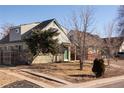 Charming two-story home with a mix of brick and siding, complemented by mature trees and a well-kept lawn at 3640 Elm St, Denver, CO 80207