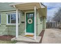 Inviting front door featuring a wreath, a 'hello' doormat, and stylish house numbers at 3640 Elm St, Denver, CO 80207