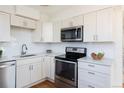 Modern kitchen features stainless steel appliances, white cabinets, and bright countertops at 3640 Elm St, Denver, CO 80207