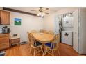 Cozy dining room with wood floors, ceiling fan, seating for six and convenient laundry closet at 12151 Melody Dr # 202, Westminster, CO 80234