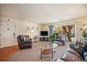 Comfortable living room featuring a sliding glass door, plush furnishings, and ample natural light at 12151 Melody Dr # 202, Westminster, CO 80234