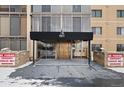 The condo entrance with a bronze door shows signage and brick features around the covered entry at 7877 E Mississippi Ave # 1107, Denver, CO 80247