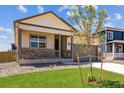Beautiful home with a cozy porch and a well-manicured lawn, offering a welcoming and picturesque setting at 845 Leeward St, Lochbuie, CO 80603