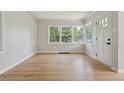 Spacious living room with hardwood floors and a large window offering natural light and views of the yard at 2709 S Franklin St, Denver, CO 80210