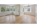 Bright living room features hardwood floors, white walls, and large windows providing natural light at 2709 S Franklin St, Denver, CO 80210