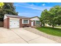 Inviting home with an attached garage, lush lawn and mature tree in a quiet neighborhood at 245 Main St, Broomfield, CO 80020