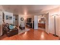 Open-concept living room flowing into the bedroom with hardwood floors, with ample space for relaxing and entertaining at 7945 York St # 2, Denver, CO 80229