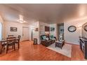 Inviting living room with hardwood floors, comfortable seating, and a dining area, creating a welcoming space at 7945 York St # 2, Denver, CO 80229