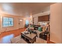 Comfortable living room with a large window, providing natural light, and a dining area, perfect for gatherings at 7945 York St # 2, Denver, CO 80229