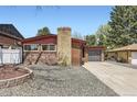 Charming brick home with a spacious driveway and attached garage at 8375 W 17Th Ave, Lakewood, CO 80214