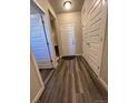 Inviting hallway featuring wood-style flooring and bright white paneled doors at 2383 S Troy Ct, Aurora, CO 80014