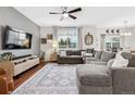Spacious living room with hardwood floors, a large sectional sofa, and stylish decor at 25148 E Lake Pl, Aurora, CO 80016
