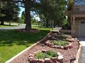 Gorgeous lawn with garden beds, mature trees, and impeccable landscaping at 1095 Lake Woodmoor Dr, Monument, CO 80132