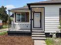 Close up of the freshly painted front exterior featuring a small porch and steps leading to the front door at 449 King St, Denver, CO 80204
