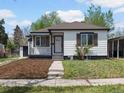 Charming home with a well-manicured lawn, fresh mulch, and sidewalk leading up to the front door at 449 King St, Denver, CO 80204