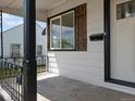 Cozy front porch featuring a view of the yard and neighborhood, plus a mailbox and dark shutters at 449 King St, Denver, CO 80204