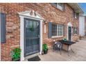 Inviting brick townhome entrance with secure screen door and outdoor seating area at 14034 E Utah Cir, Aurora, CO 80012