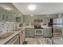 Stylish kitchen with stainless steel appliances, white countertops, and decorative backsplash at 14034 E Utah Cir, Aurora, CO 80012