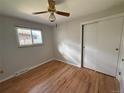 Cozy bedroom featuring hardwood floors, a ceiling fan, and a sliding-door closet at 2991 S Whiting Way, Denver, CO 80231