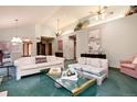 Light-filled living room featuring vaulted ceilings and a decorative display shelf at 7500 E Dartmouth Ave # 16, Denver, CO 80231