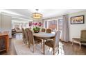Bright dining room features hardwood floors, a large window, and an elegant light fixture at 290 Dexter St, Denver, CO 80220