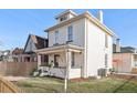 Charming two-story home featuring a well-maintained lawn, classic architectural details, and a welcoming covered front porch at 300 Inca St # A, Denver, CO 80223