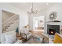 Bright and inviting living room featuring hardwood floors, a decorative fireplace, and a staircase leading to the upper level at 300 Inca St # A, Denver, CO 80223