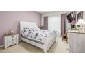 Cozy bedroom with a queen bed, soft lighting, and neutral color palette at 8465 Pebble Creek Way # 102, Highlands Ranch, CO 80126