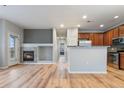 Inviting living space with fireplace, hardwood floors, and an open kitchen area with bar seating at 13000 W Grant Cir # C, Thornton, CO 80241