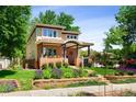 Charming two-story home featuring a welcoming front porch and professionally landscaped front yard at 1156 S Columbine St, Denver, CO 80210
