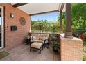Inviting front porch offers a cozy seating area with brick accents and tranquil outdoor views at 1156 S Columbine St, Denver, CO 80210