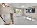 Bright living room with new neutral carpet, large windows, and a classic white front door at 9099 W Harvard Pl, Lakewood, CO 80227