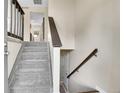 The home features a well-lit stairway with carpeted steps and classic wooden railing, leading to the upper level at 9099 W Harvard Pl, Lakewood, CO 80227