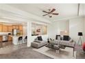 Open living room with a modern sofa and a view into the kitchen at 4849 Halifax Ct, Denver, CO 80249