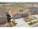An elevated view of a two-story home with a two-car garage and well-manicured landscaping at 8621 S De Gaulle Ct, Aurora, CO 80016