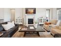 Cozy living room with a fireplace, stylish furniture, and tasteful decor at 8621 S De Gaulle Ct, Aurora, CO 80016