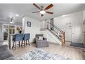 Cozy living room features modern decor, wood floors, and an open staircase at 3089 S Winston St, Aurora, CO 80013