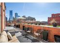 Enjoy this city view from the rooftop patio, complete with potted plants, a lounge area, and blue skies at 1501 Wazee St # 4B, Denver, CO 80202