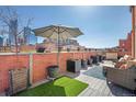 Relax on this rooftop patio with comfortable seating, lush plants, and city views, perfect for entertaining at 1501 Wazee St # 4B, Denver, CO 80202