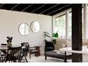 Open living area with black ceiling, modern furniture, and ample natural light from large windows at 7918 Raleigh Pl, Westminster, CO 80030