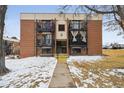 Brick apartment building with balconies, stairs, and landscaping at 5995 W Hampden Ave # 13G, Denver, CO 80227