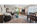 Cozy living room with sofas, area rug, and television at 5995 W Hampden Ave # 13G, Denver, CO 80227