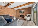 Inviting living room featuring a brick fireplace and sliding glass door for natural light at 9675 E Kansas Cir # 45, Denver, CO 80247